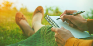 Mujer escribiendo en cuaderno